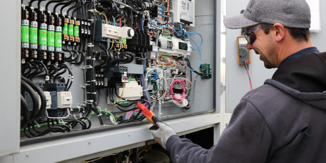 Employee Ownership at VETS Group photo of worker in front of electrical panel
